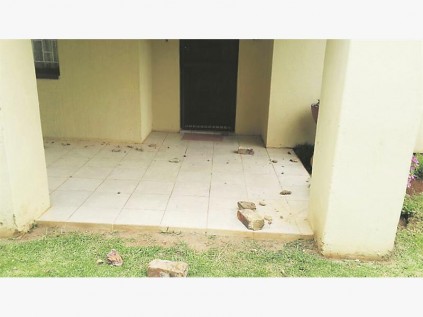 The impact of the crash sent bricks flying, even onto the porch of one of the homes.