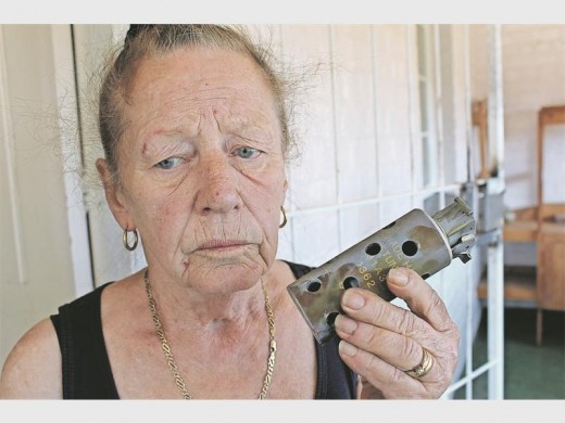 David's mother, Monica Pickering, holds up a tear gas canister that was fired into their home by police.