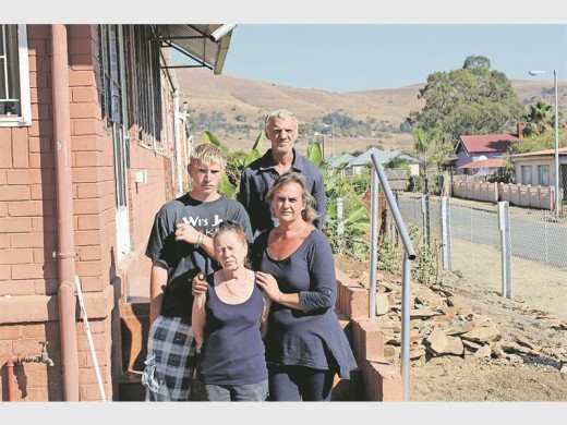 Jonathan de Beer (back) has been thrown at with hot water, Willem Wewege (back) was assaulted, Lindy van der Walt was bleeding from her head and her mother in law says she witnessed everything. The purple house in the background is where Solomon lives.
