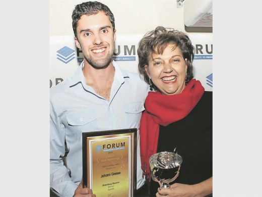 Johan Gresse, best headline writer and second best sports writer in South Africa, receiving his awards from Ms Karen Geurtse, General Manager of Capital Media.