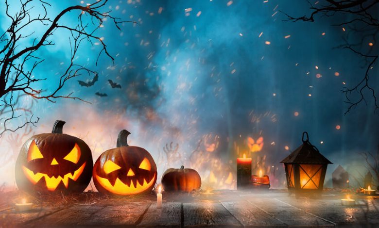 Halloween pumpkins on dark spooky forest.