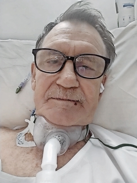 Old man who with machine in his throat.