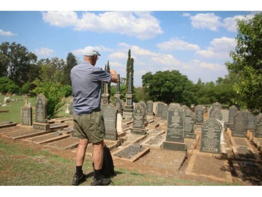 A symposium attendee takes a photo of the Jewish cemetery.
