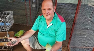 Man, who died recently, between his birds.