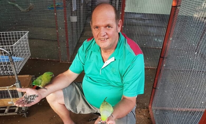 Man, who died recently, between his birds.