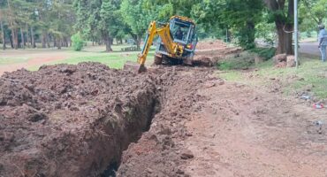 Photo of Yellow TLB digging a sewage line.