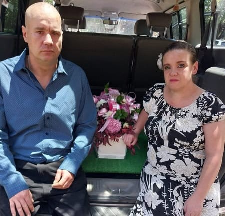 Man and woman at funeral of their baby.
