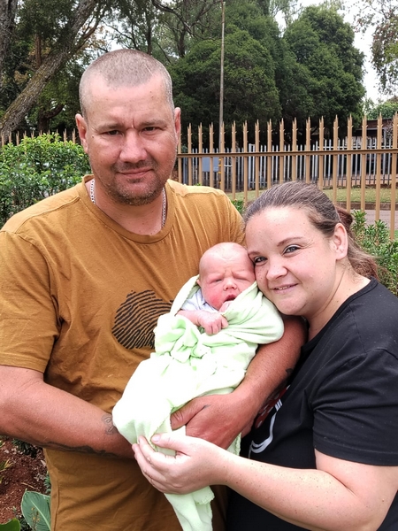 Proud father and mother with newborn baby.