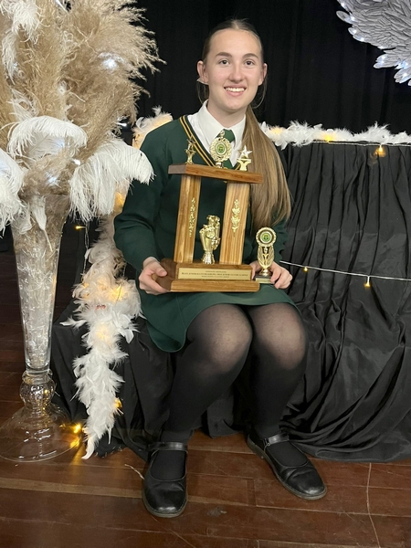 Girl with trophies on her lap.