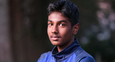 Head and shoulders photo of a boy wearing a blue jacket.