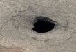 Photo of a sinkhole on the road.