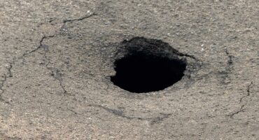 Photo of a sinkhole on the road.