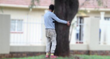 Drug addict hugging a tree.