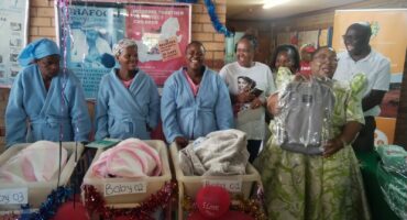Mayor Minah Bahula presents gifts to babies born on Christmas Day at the Jane Furse Hospital.
