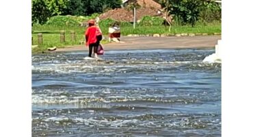 A woman walking over a flooded bridge in Middelburg.