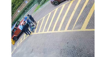 The female guard on the ground surrounded by witnesses., and the alleged shooter.