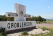 Welcome sign for Groblersdal, with "Welkom" and "Welcome" in bold letters against a bright sky. The scene conveys a warm and inviting atmosphere.