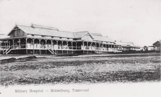 An old black and white photo depicting a large, historic building with intricate architectural details.