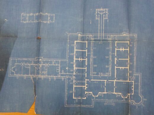 Architectural blueprint displaying the hospital's floor plan, including room layouts and measurements.