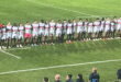 A group of Tuks rugby players standing together on a rugby field, dressed in Tukkies rugby shirts, ready for a game.