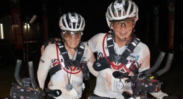 Two women on their bicycles.