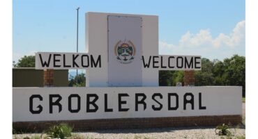 Welcome sign for Groblersdal on a sunny day. It features the words "Welkom" and "Welcome" above the town's name, set against a clear sky.