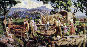 A group of pioneers builds wooden wagon wheels under trees, with mountains in the background. The scene conveys industry and collaboration.