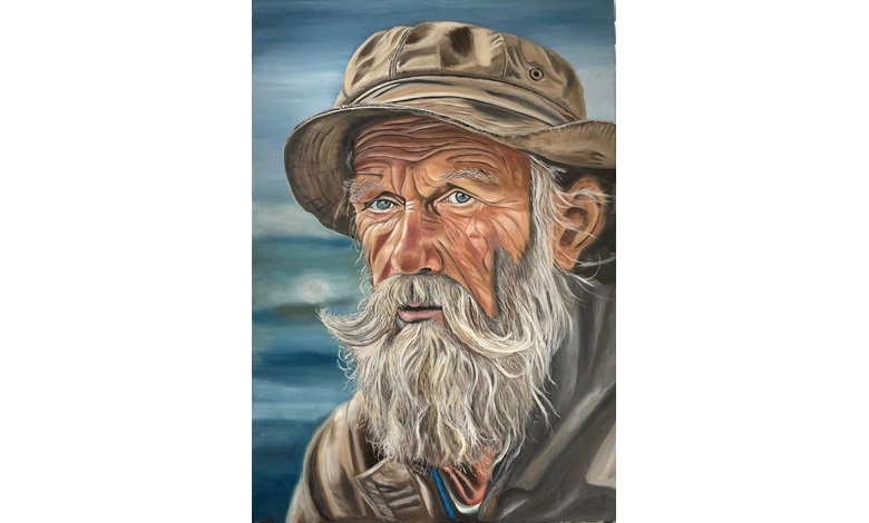 Portrait of an elderly man with a rugged beard and expressive eyes, wearing a weathered hat and jacket, conveying wisdom and resilience against a blurred blue background.
