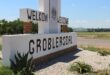 A roadside sign reads “Welkom Welcome Groblersdal” with a crest above. It’s set against a rural landscape, blue sky, and greenery, evoking a welcoming tone.