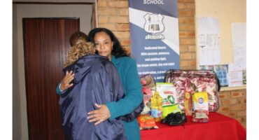 Principal Eleanor Pinetown hugging the oldest child after receiving much-needed donations for her younger sisters and parents.Principal Eleanor Pinetown, fire, house fire, shelter, home