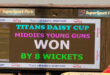 Scoreboard at SuperSport Park displays "Titans Daisy Cup: Middies Young Guns Won by 8 Wickets." Bold text, celebratory colors, reflects victory.