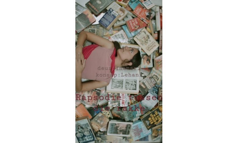 A woman in a red dress lies on a floor covered with books in various languages. Her expression is contemplative, surrounded by colorful book covers.