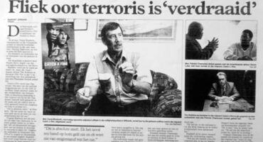 Black and white newspaper article with bold headline about a film, "Catch a Fire," criticized for misrepresentation. Features images of three men in discussion.