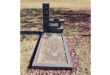 Gravesite with a modern headstone labeled "SMIT." The grave is surrounded by fallen leaves, conveying a serene and contemplative autumn setting.
