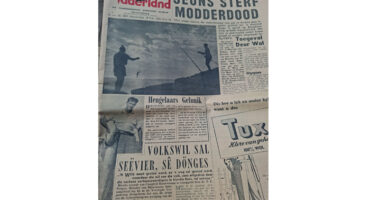 Alt text: A vintage newspaper page featuring a large headline in Afrikaans. The black-and-white image shows two people fishing on a rocky shoreline. Various articles and an advertisement are visible, adding a historical and nostalgic tone to the scene.