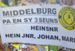 Banner with "Middelburg Marathon Club" logo and text honoring "Pa en sy 3 seuns: Hein Snr, Hein Jnr, Johan, Marc." Background shows marathon runners.