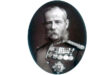 Portrait of a bearded man wearing military medals, showcasing pride and honor in his expression.