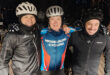 Three men in helmets stand side by side, displaying camaraderie and readiness for an activity or event.