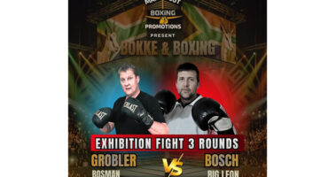 Two men in boxing gear pose in front of a banner reading "Exhibition Fight 3 Rounds."
