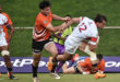 Rugby players engaged in a dynamic match, showcasing teamwork and athleticism on the field.