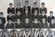A black and white photo featuring a group of boys posing together, showcasing camaraderie and teamwork.