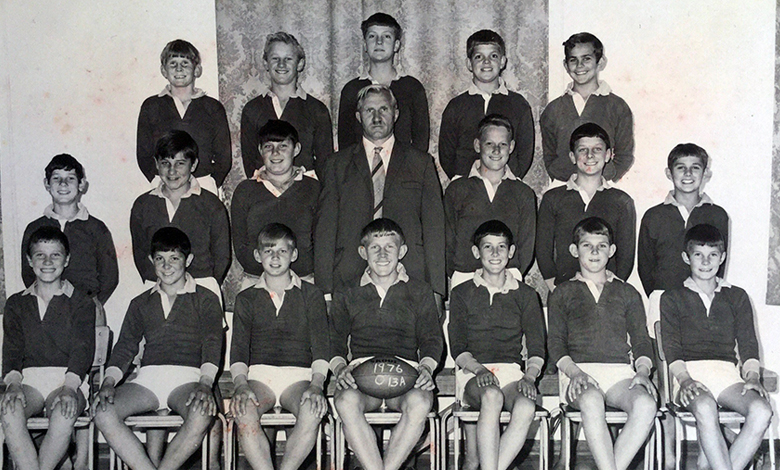 A black and white photo featuring a group of boys posing together, showcasing camaraderie and teamwork.