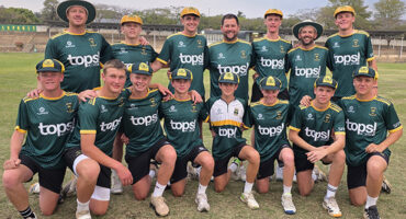 A group of young men wearing green and yellow uniforms, standing together in a team formation.