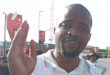A man gestures with his hand, emphasizing a point during a conversation or presentation.