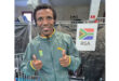 A cheerful man with a thumbs up gesture, indicating satisfaction and encouragement.