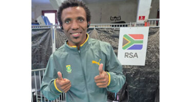 A cheerful man with a thumbs up gesture, indicating satisfaction and encouragement.