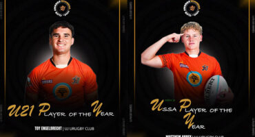 Two young men wearing orange shirts pose together on a promotional poster.