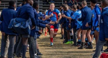 Jurgens Bezuidenhout, van Ligbron draf verby 'n erewag van skoliere in skooldrag.