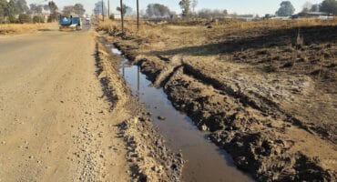 A long, water-filled ditch runs parallel to Havenga Road in Ermelo, highlighting ongoing infrastructure and drainage issues.