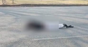 : Feet of a man lying on Fourie Street after being hit by a truck, with the rest of his body blurred for privacy